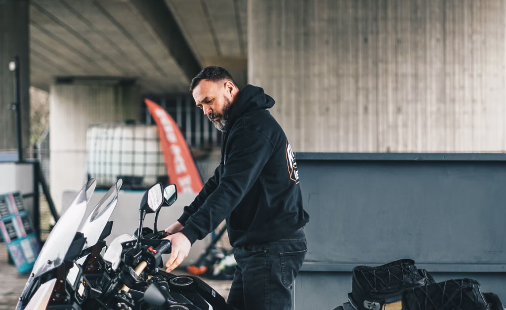 motorcycle instructor standing next to motorcycle