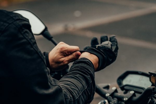 man putting on motorcycle gloves