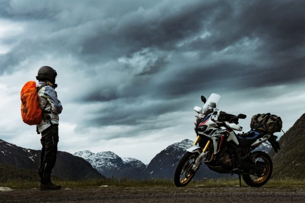 motorcycle touring rider looking at their bike